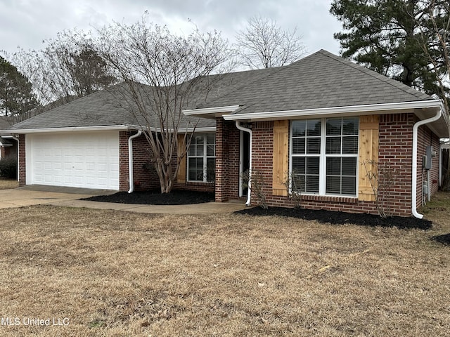 ranch-style home featuring a garage and a front lawn