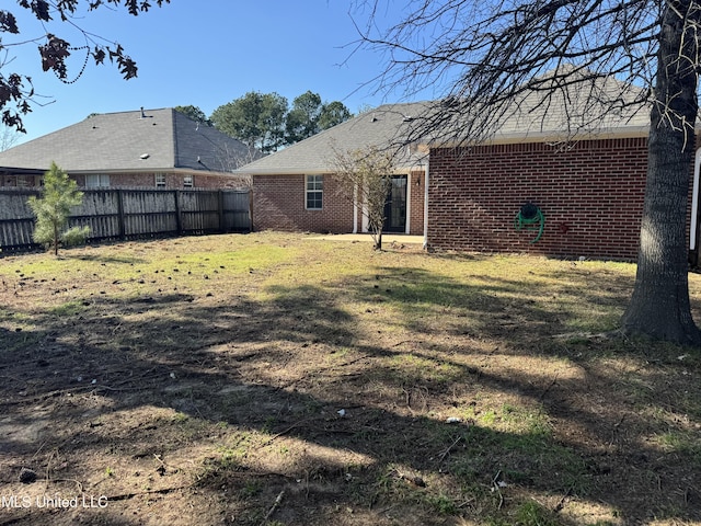 rear view of property with a lawn