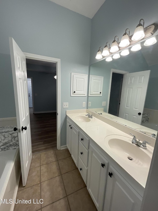 bathroom featuring vanity, a tub to relax in, and tile patterned floors