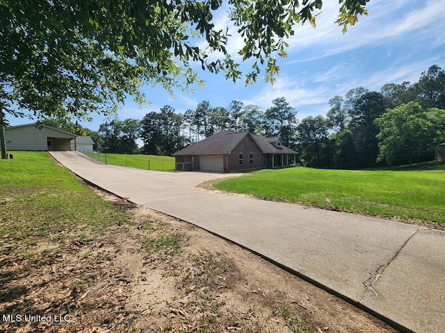 view of side of property featuring a lawn and a garage