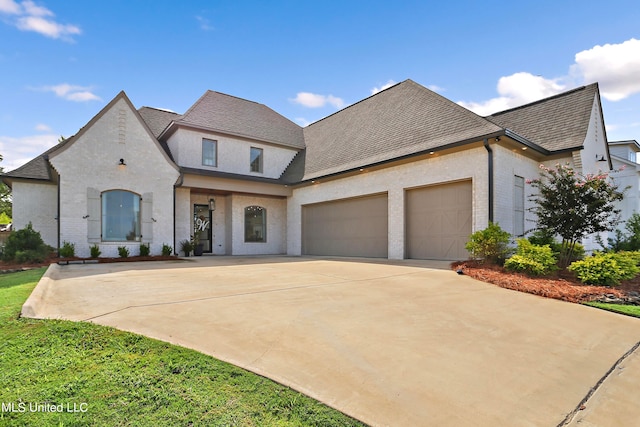 french country inspired facade featuring a garage