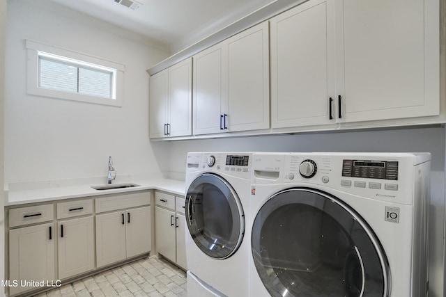 laundry room with sink, cabinets, and washing machine and clothes dryer