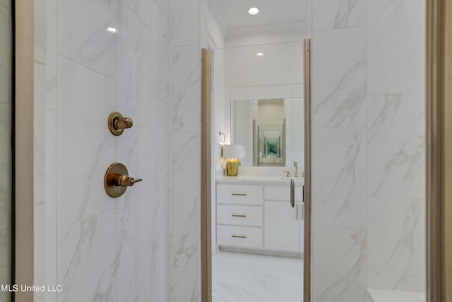 bathroom featuring vanity and tiled shower