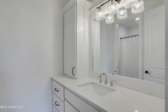 bathroom featuring vanity and a shower with shower curtain