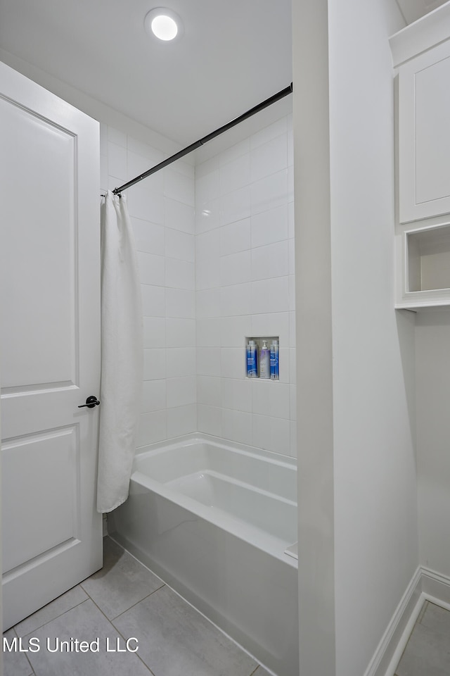 bathroom featuring shower / bath combo and tile patterned floors