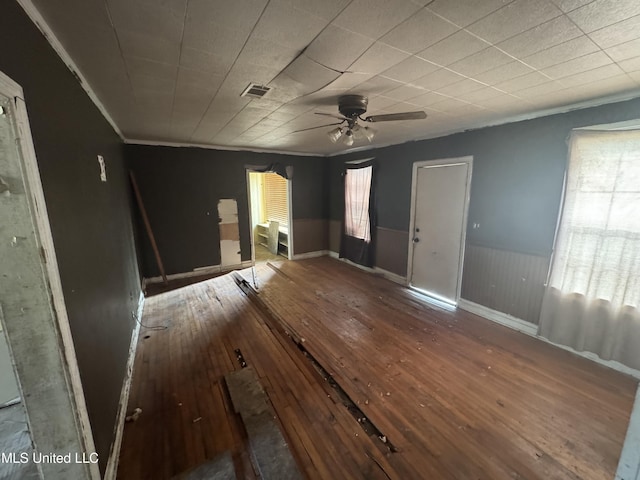 interior space with ceiling fan, ornamental molding, and wood-type flooring