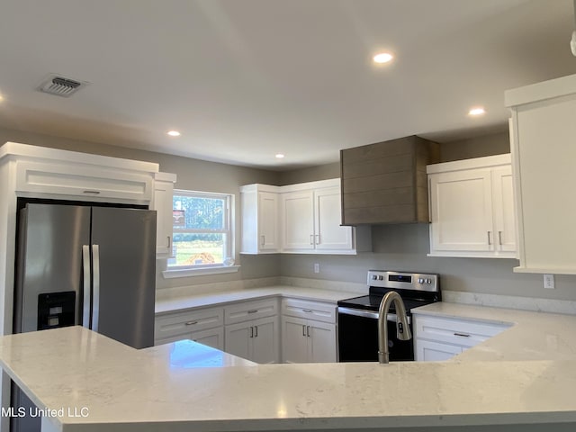 kitchen featuring light stone countertops, white cabinets, and stainless steel appliances