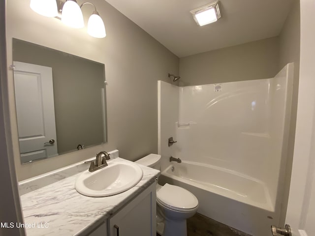 full bathroom with toilet, vanity, and washtub / shower combination