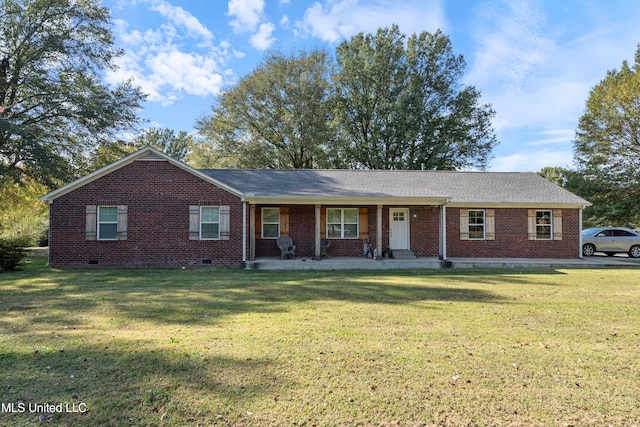 ranch-style home featuring covered porch and a front lawn