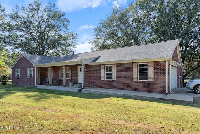 single story home with covered porch, a front yard, and a garage