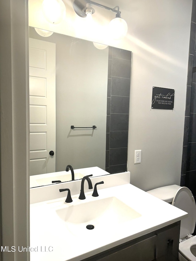 bathroom featuring toilet and vanity