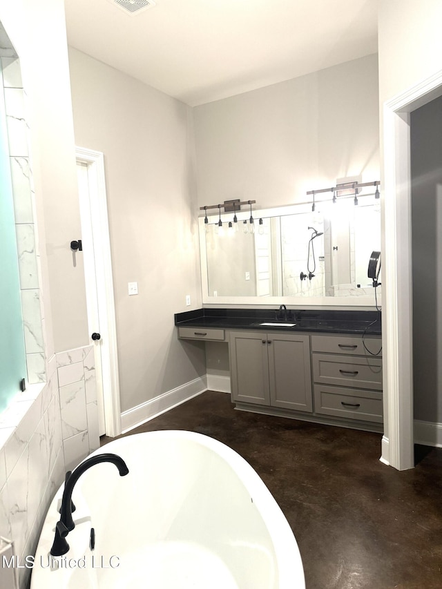 bathroom with tile walls, vanity, a bathtub, and concrete flooring