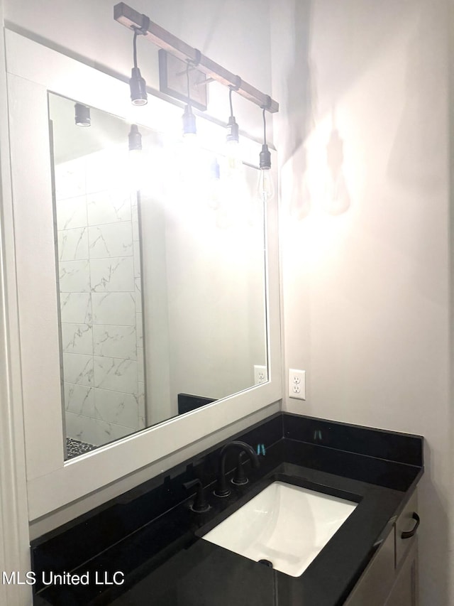 bathroom with vanity and tiled shower