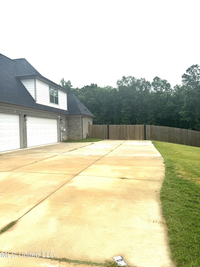 view of sport court featuring a lawn