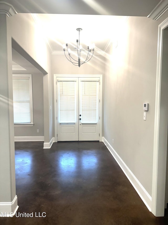 foyer featuring crown molding, a notable chandelier, and french doors