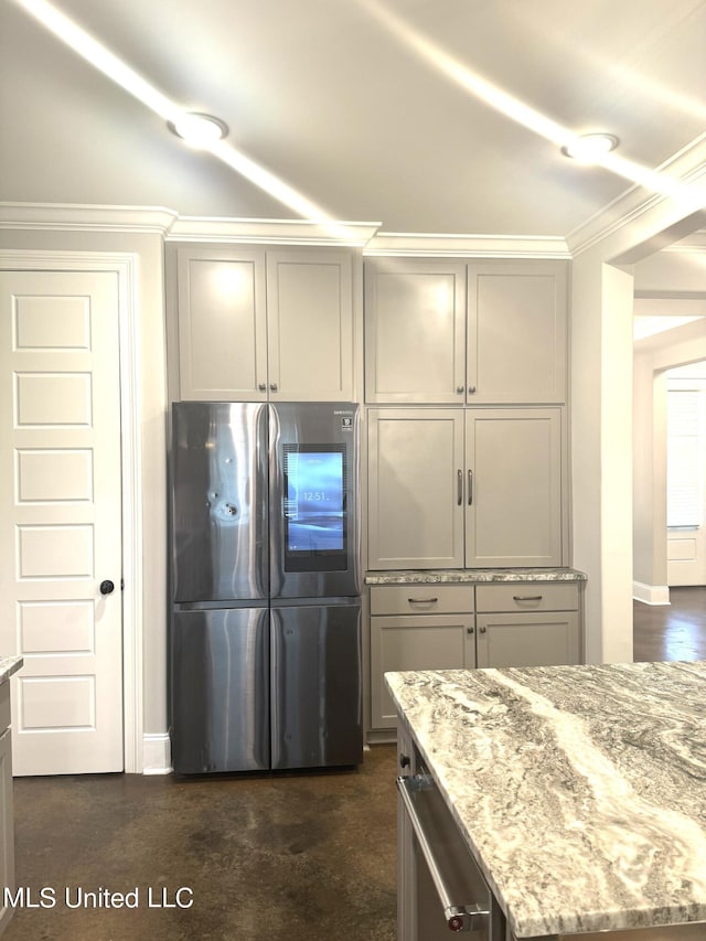 kitchen featuring gray cabinets, crown molding, stainless steel fridge, and light stone counters