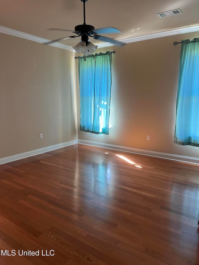 spare room with ornamental molding, dark wood-type flooring, and ceiling fan