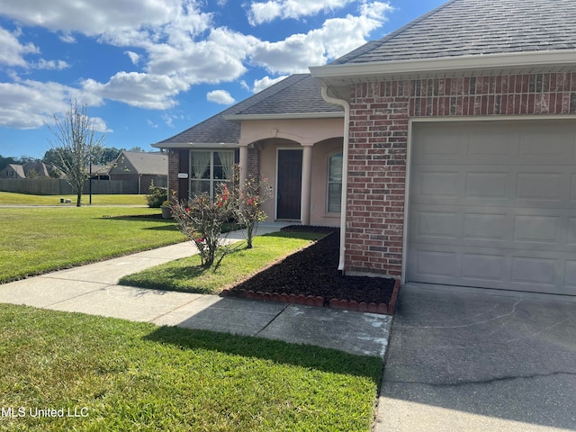 view of front of home with a front lawn and a garage