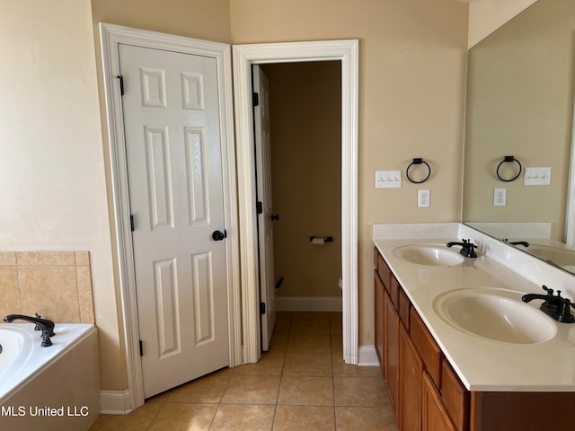 bathroom with vanity, tile patterned floors, and a washtub