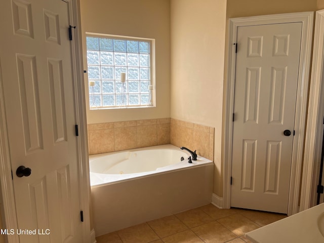 bathroom with a tub and tile patterned flooring