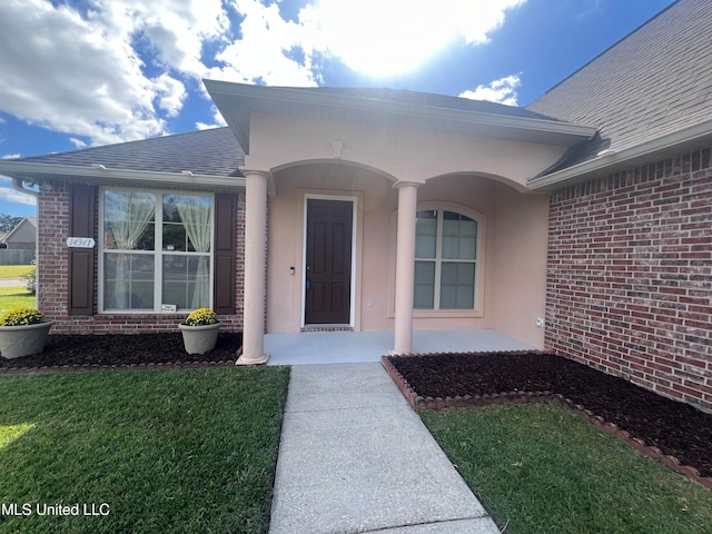 doorway to property with a yard