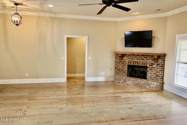 unfurnished living room featuring crown molding, baseboards, wood finished floors, and a ceiling fan