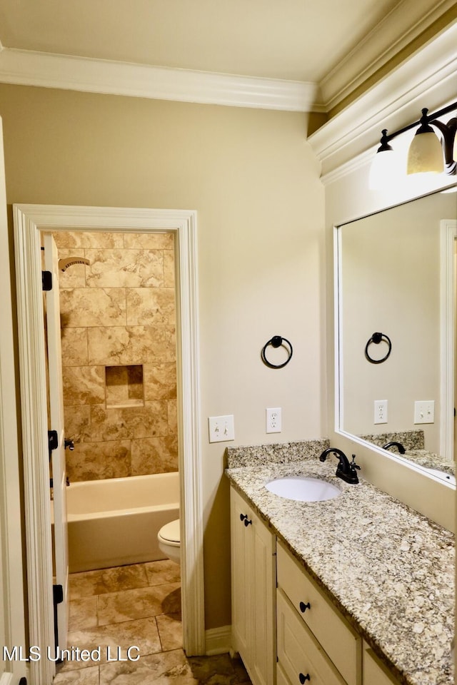 full bath with toilet, vanity, ornamental molding, and washtub / shower combination