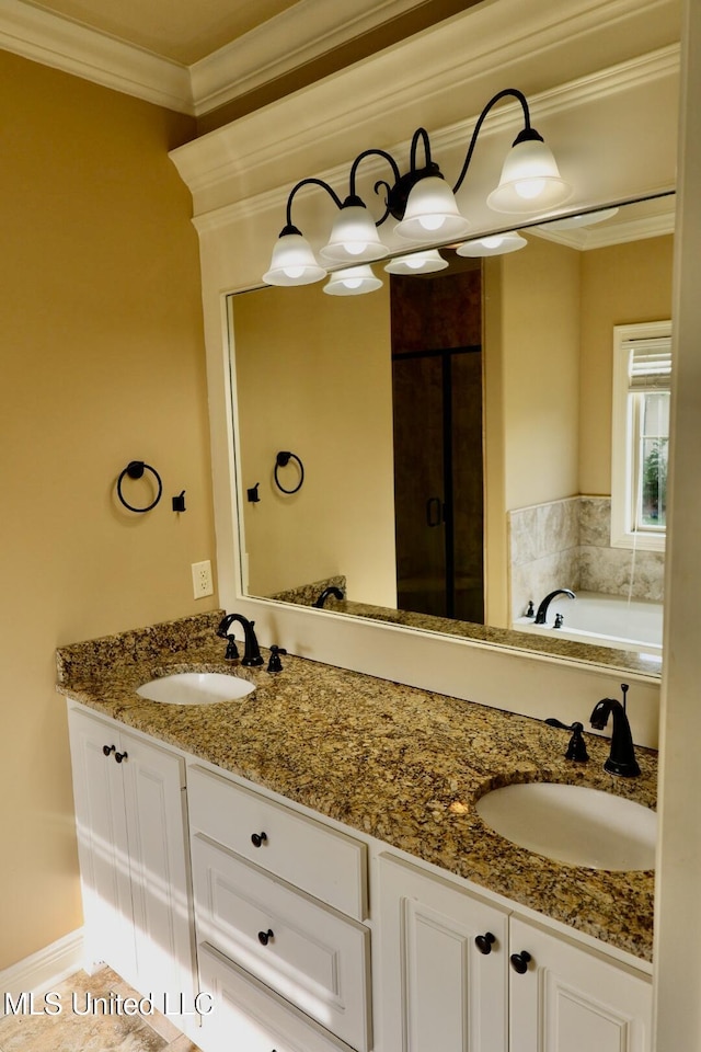 full bath with double vanity, a bath, ornamental molding, and a sink