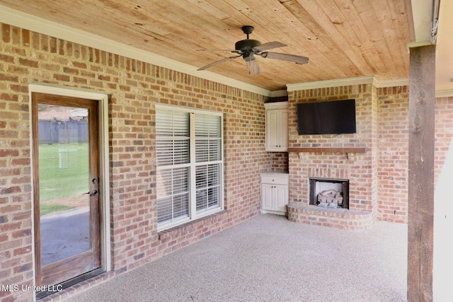 view of patio with a ceiling fan and an outdoor brick fireplace