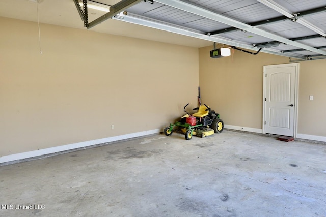 garage with baseboards and a garage door opener