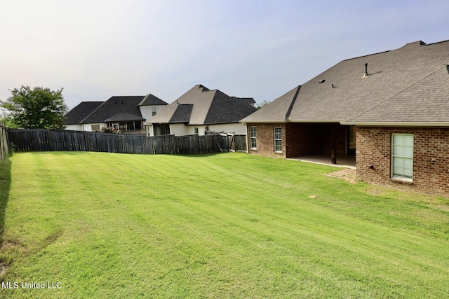 view of yard with fence and a patio