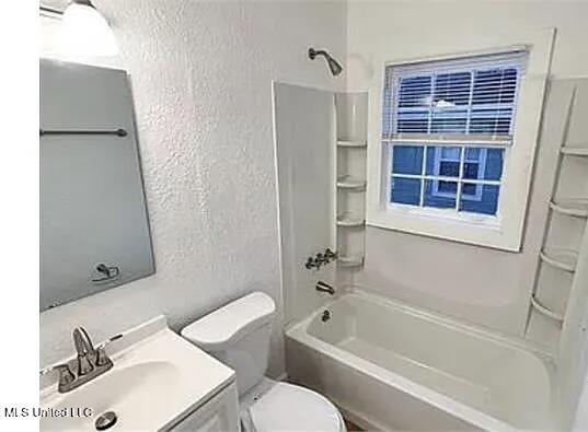 1325 Fourth Ave, Jackson, MS 39209 - bathroom featuring a textured wall, bathing tub / shower combination, vanity, and toilet