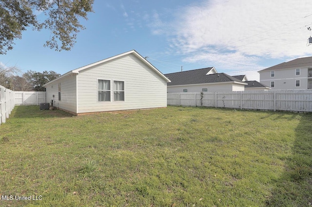 exterior space with a fenced backyard, central AC, and a yard