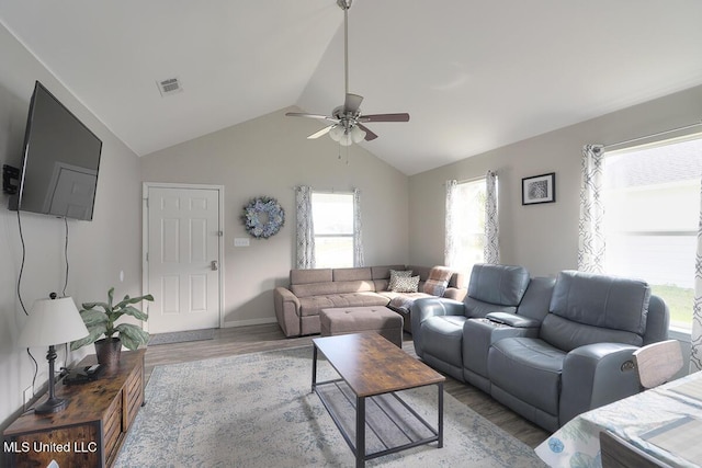 living room featuring ceiling fan, light wood-style flooring, visible vents, and vaulted ceiling