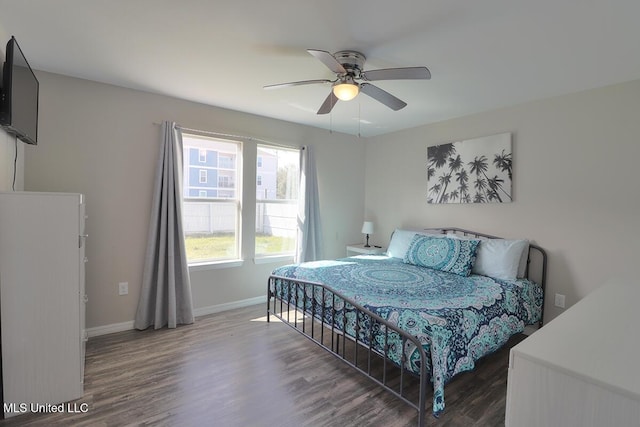 bedroom featuring ceiling fan, baseboards, and dark wood-style flooring