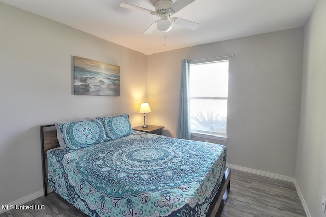 bedroom with ceiling fan, wood finished floors, and baseboards