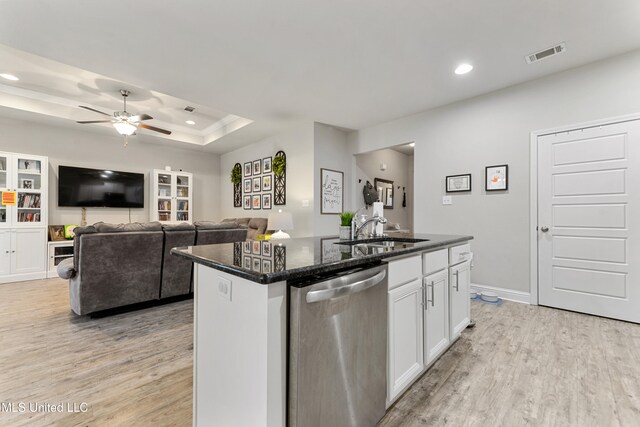 kitchen featuring sink, light hardwood / wood-style floors, white cabinets, stainless steel dishwasher, and a kitchen island with sink