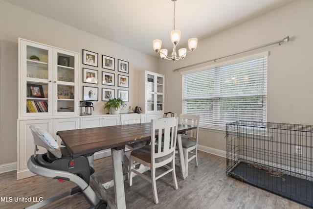 dining area with an inviting chandelier and light hardwood / wood-style floors