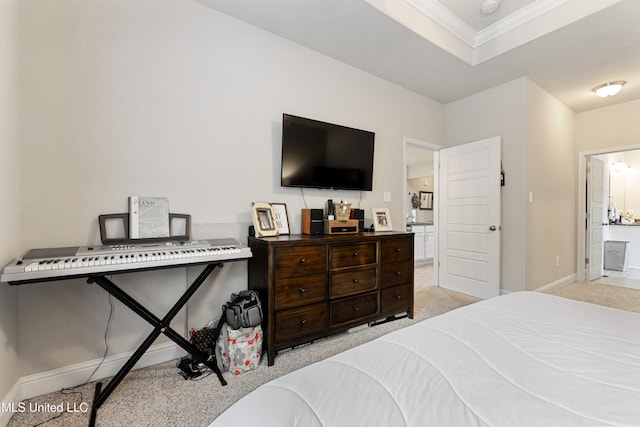 carpeted bedroom with ornamental molding and connected bathroom