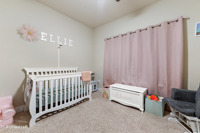 bedroom featuring carpet flooring and a crib