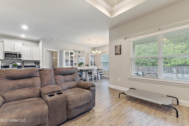 living room with light wood-type flooring and a notable chandelier