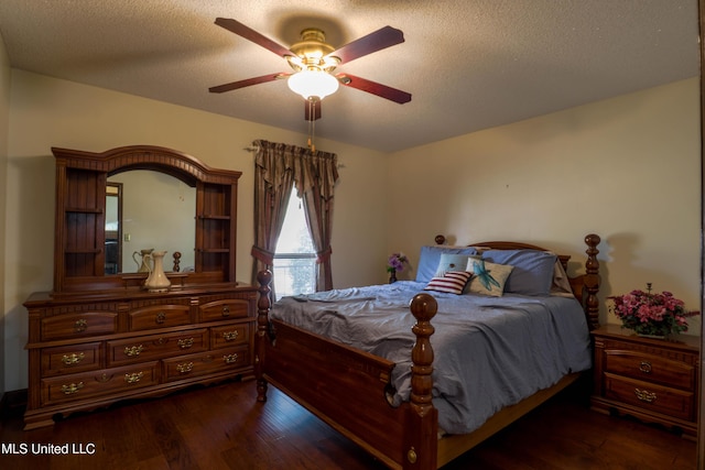 bedroom featuring ceiling fan, dark hardwood / wood-style floors, and a textured ceiling