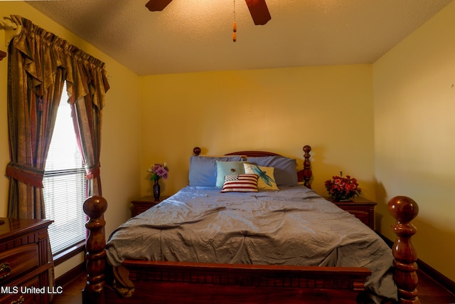 bedroom with a textured ceiling and ceiling fan