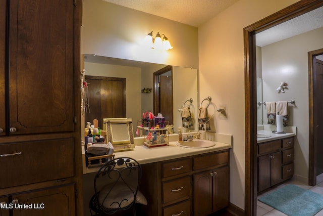 bathroom with vanity and a textured ceiling