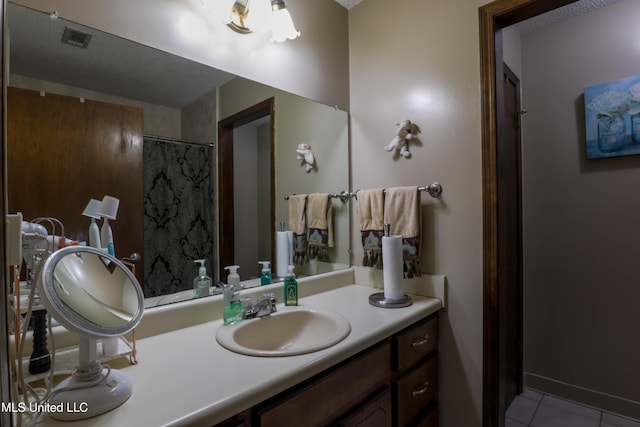 bathroom with vanity, curtained shower, and tile patterned flooring