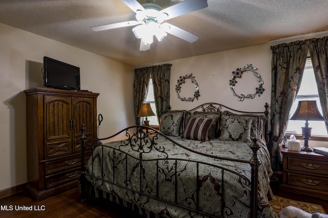 bedroom featuring ceiling fan, dark hardwood / wood-style floors, and a textured ceiling