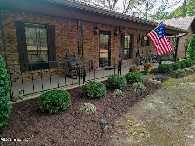 back of property with a porch