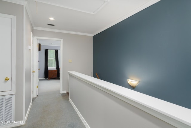 corridor featuring visible vents, baseboards, carpet flooring, and crown molding