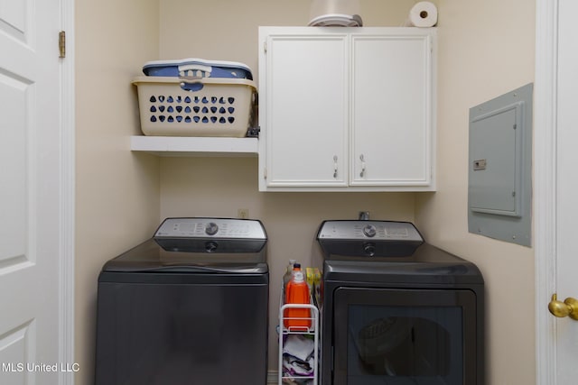 laundry area with separate washer and dryer, electric panel, and cabinet space