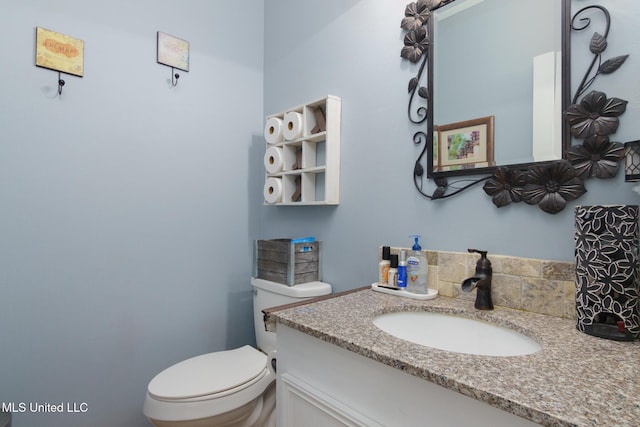 half bathroom featuring toilet and vanity